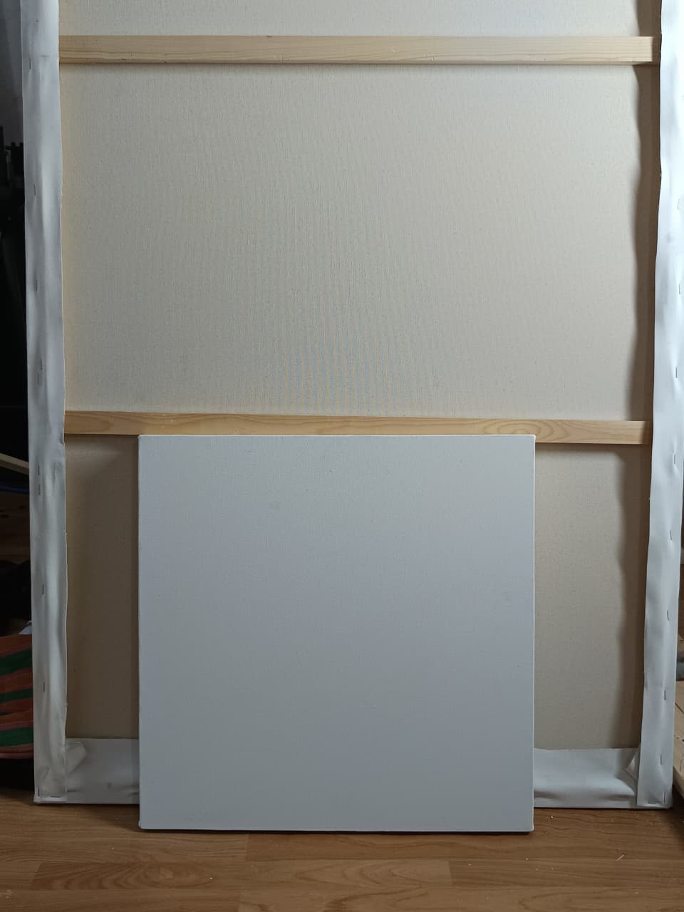 Close-up side profile of a wooden stretcher bar on a blank canvas.